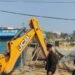 Corporation bulldozers crack down on illegal encroachments along the Harmu River, demolishing over 50 structures