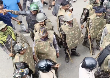 Police in protective gear facing protesting students during the clash near the Vidhan Sabha in Ranchi