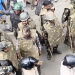 Police in protective gear facing protesting students during the clash near the Vidhan Sabha in Ranchi