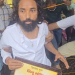 Student leader Devendra Nath Mahato on a stretcher holding a photo of Shibu Soren during the JPSC-JSSC protest march in Ranchi
